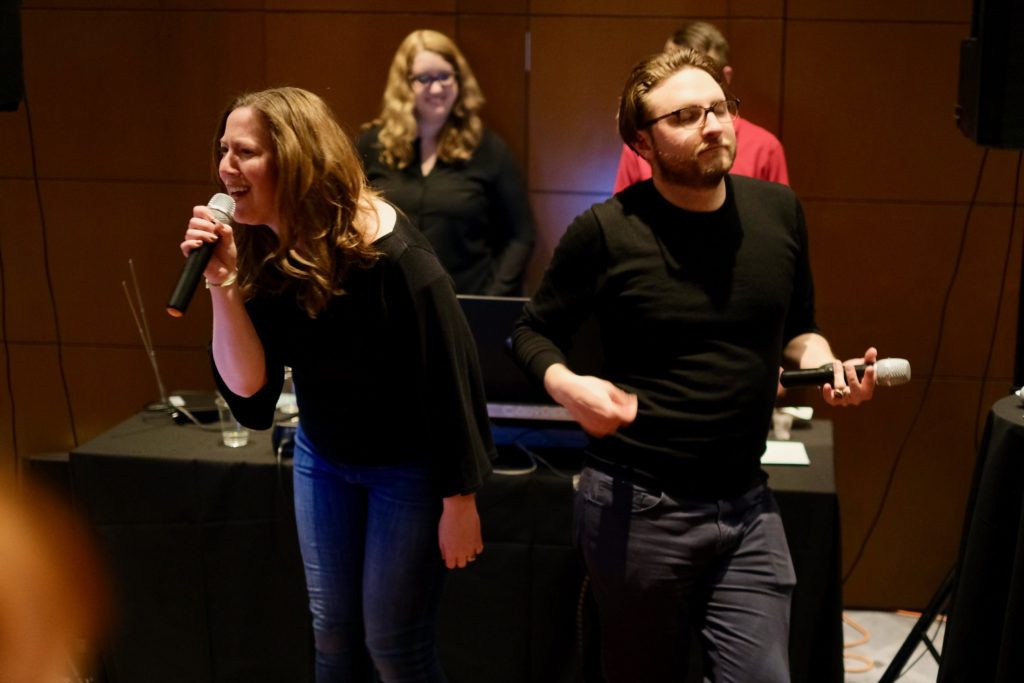The author and Margot Bloomstein performing karaoke with wireless microphones.